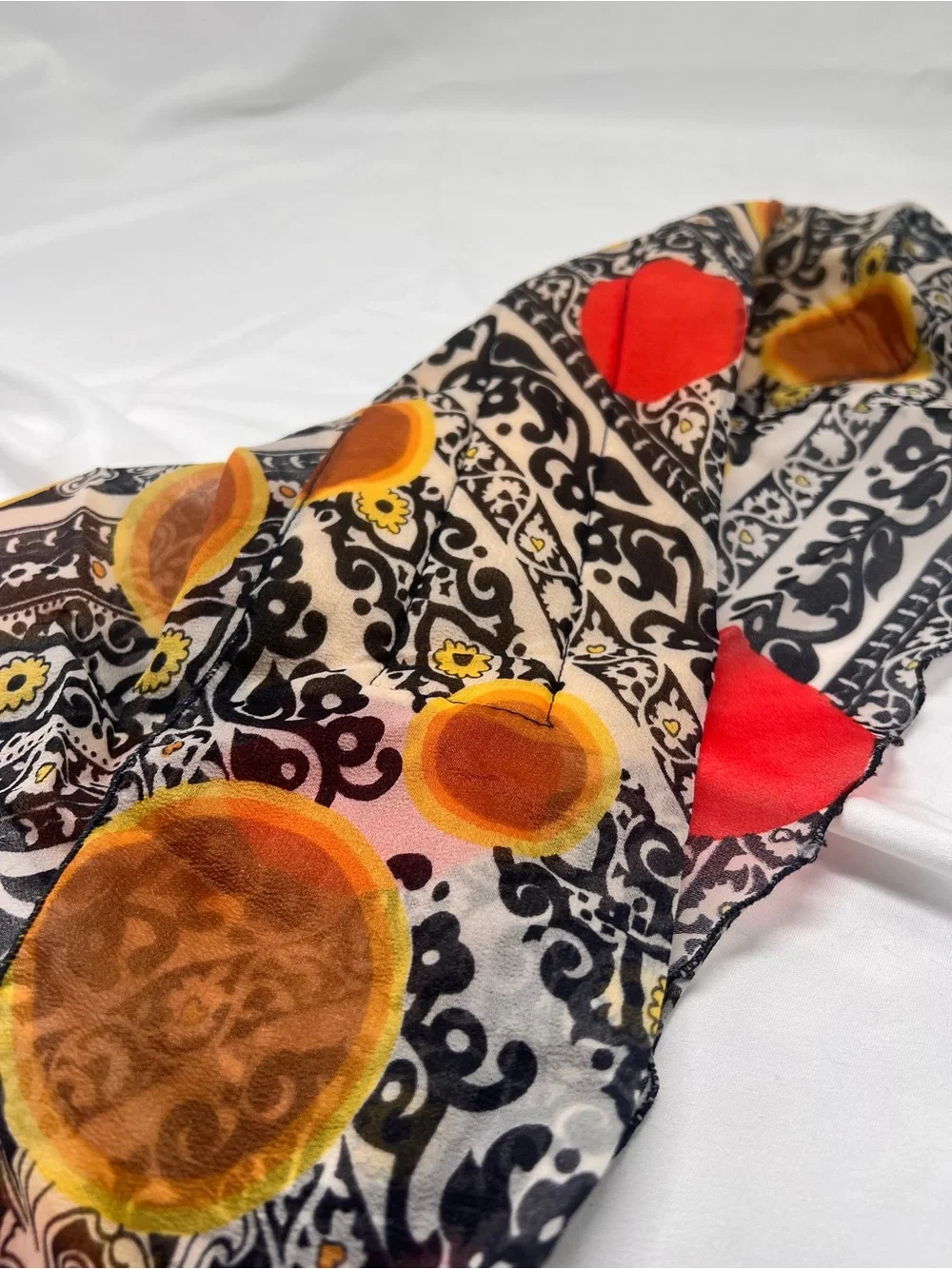 Black Patterned Scarf with Red and Mustard Dots triangle shape.